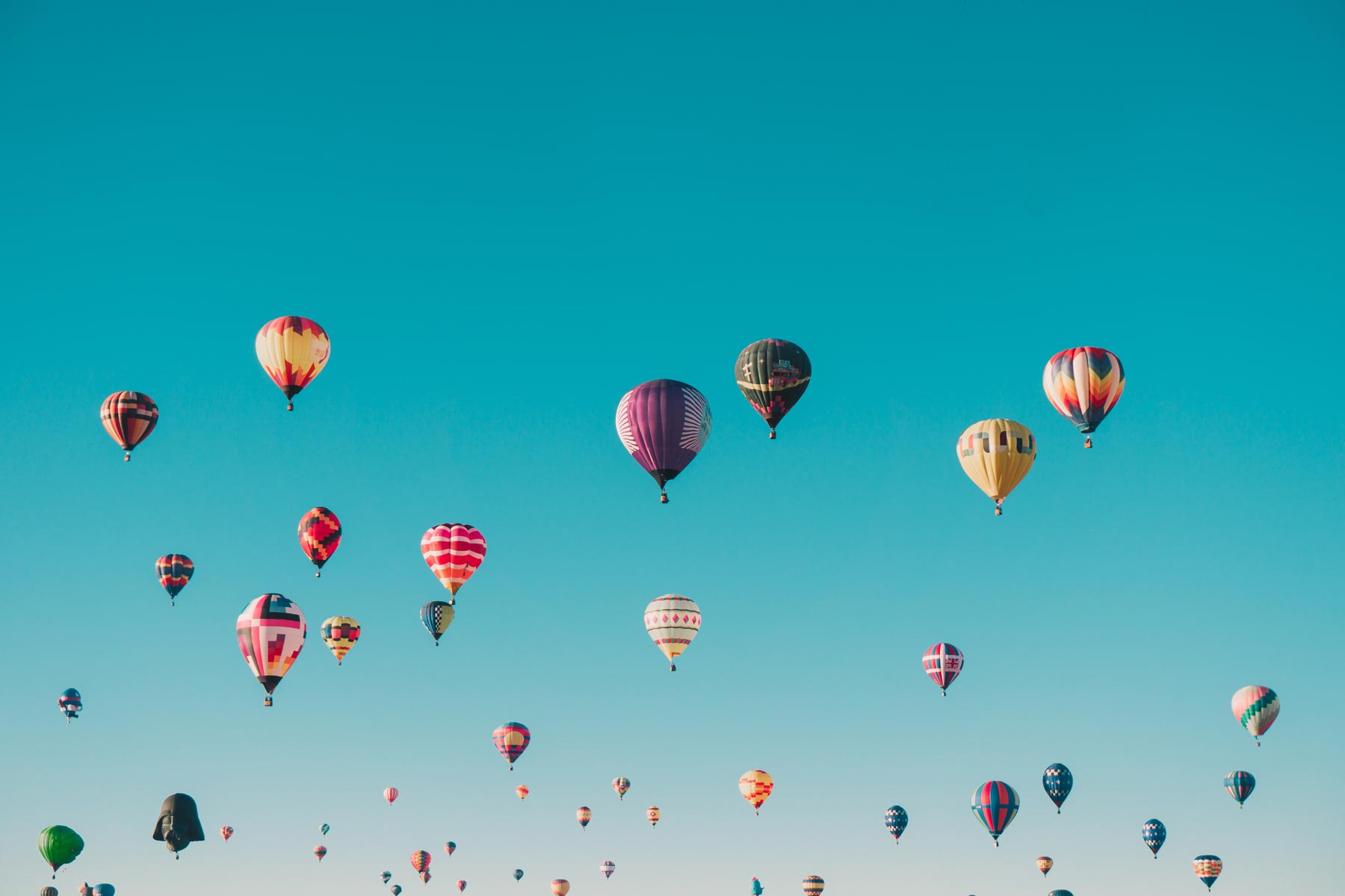 hundreds of multi-colored hot air balloons