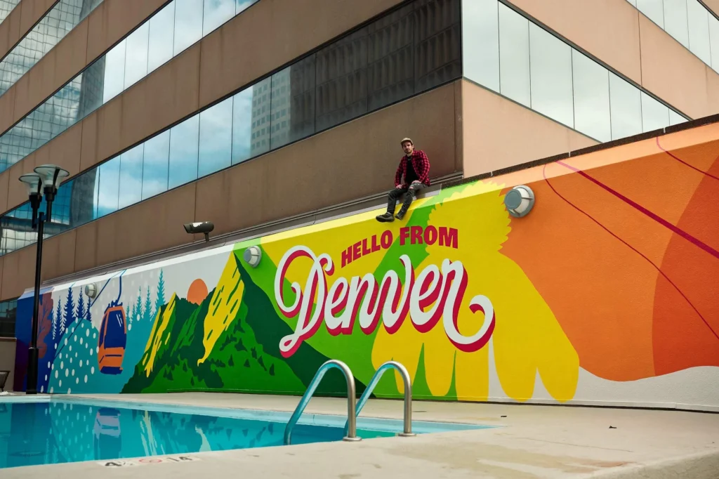Colorful four seasons mural on a hotel rooftop pool wall in downtown Denver